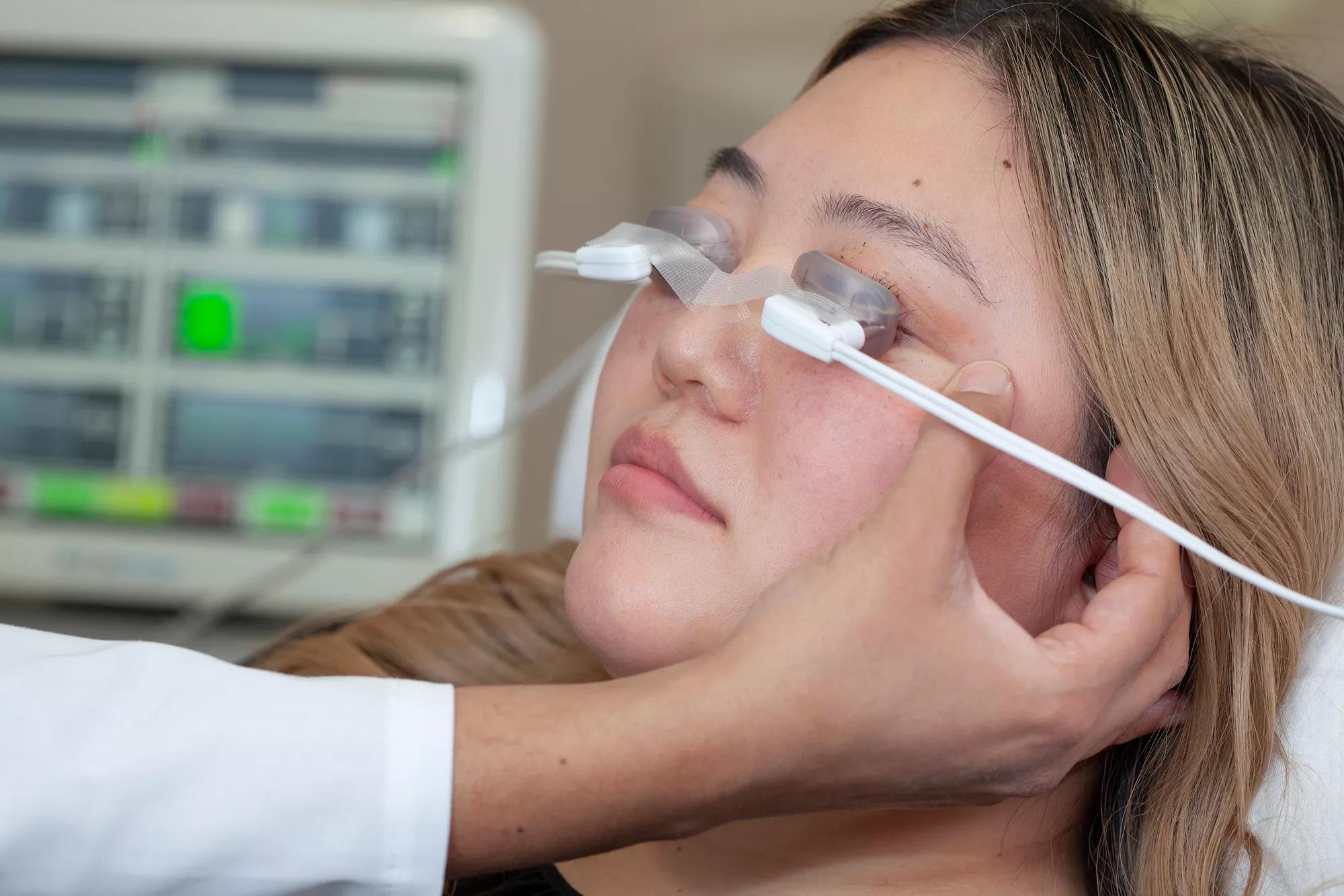 Woman with pulsation system cups on her eyes