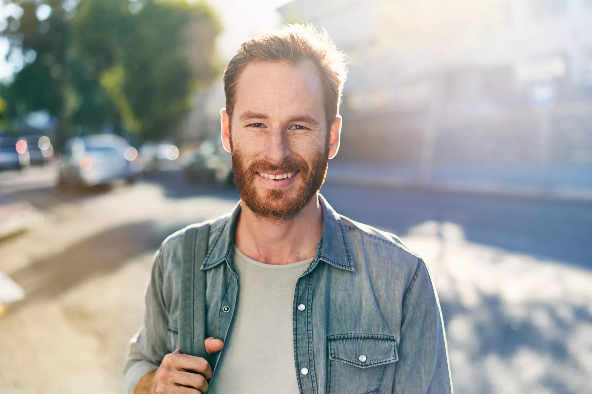 Jeune homme souriant à la caméra