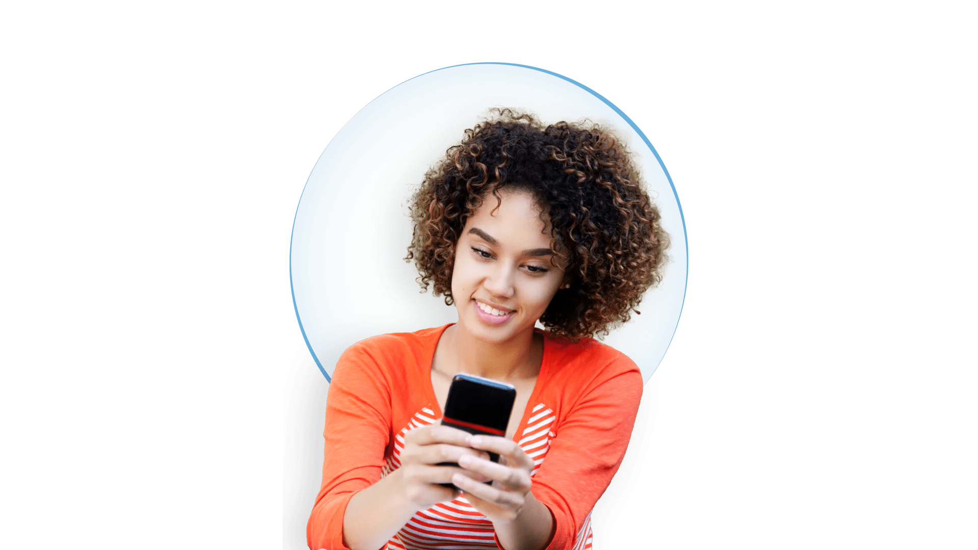 Smiling young woman with curly hair looking at the cellphone. Smiling young woman with natural hair wearing an orange striped shirt, looking at the cellphone in her hands.