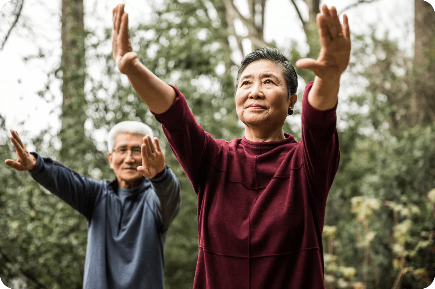 Two Asian people stretching outside