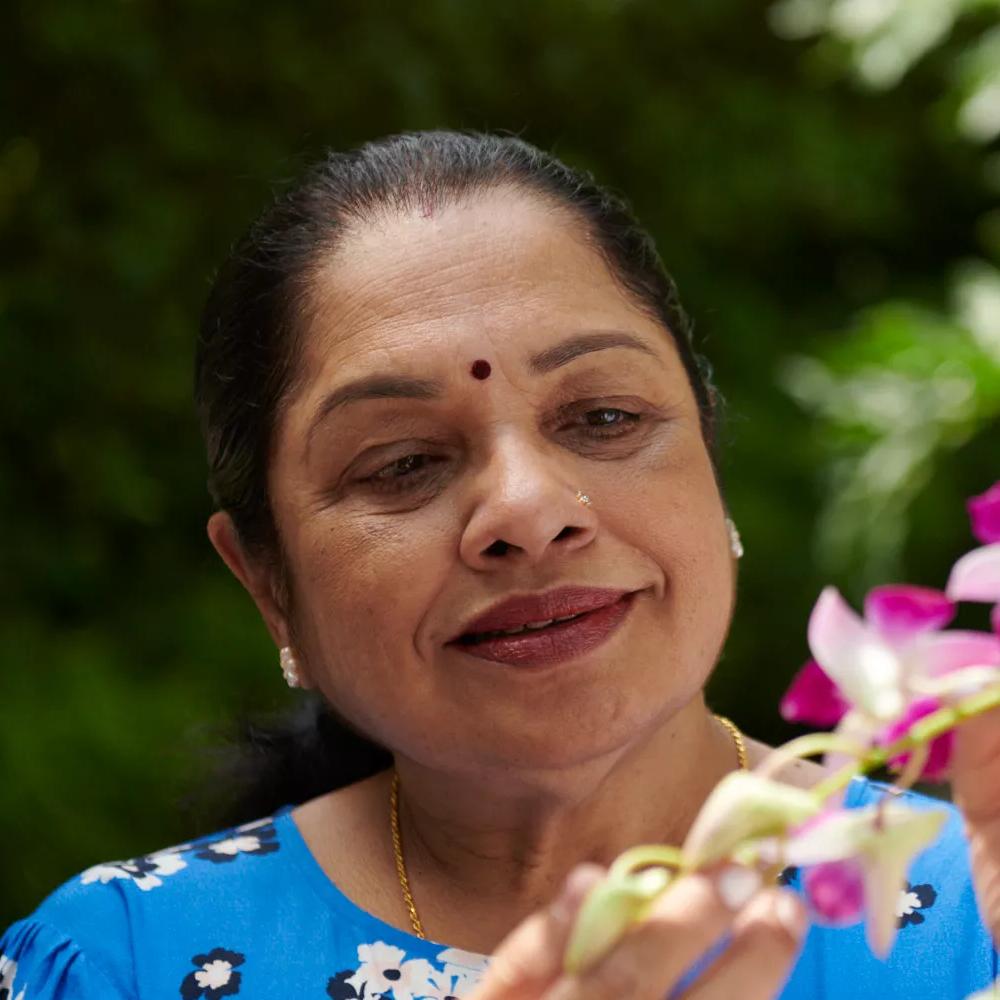 Elderly lady looking at flowers