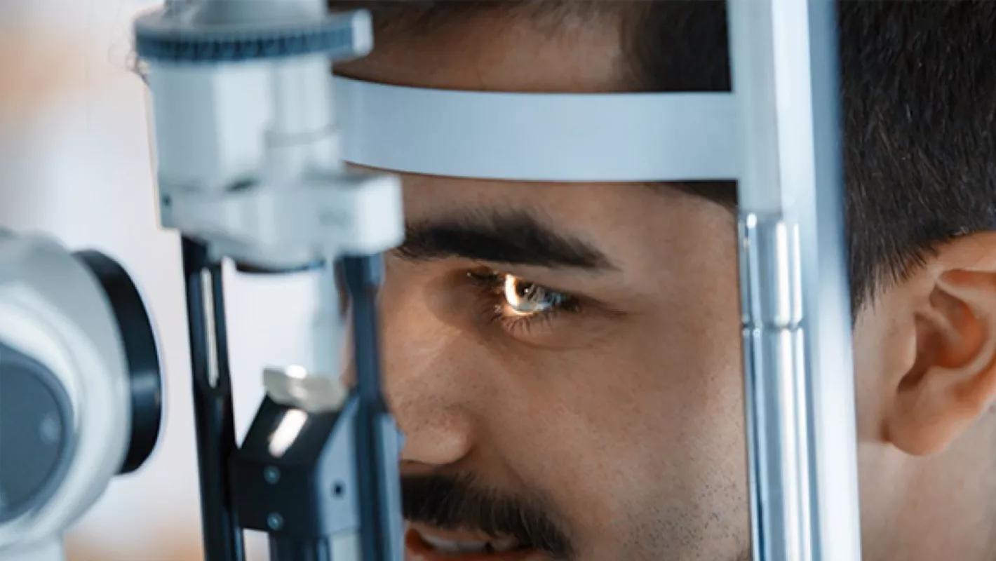 A close up image of a man having his eye examined at the eye doctor's office