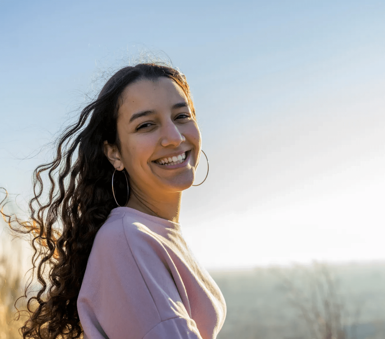 Lady smiling while looking over her shoulder