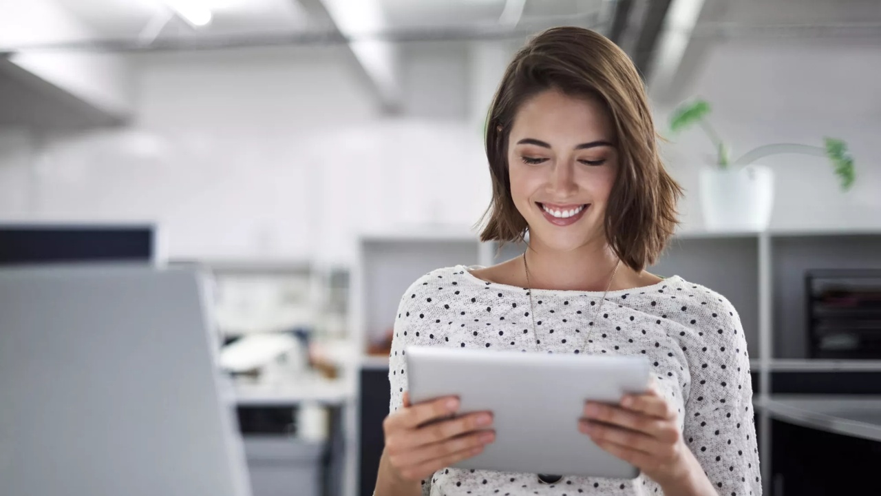 Smiling young woman looking at a tablet