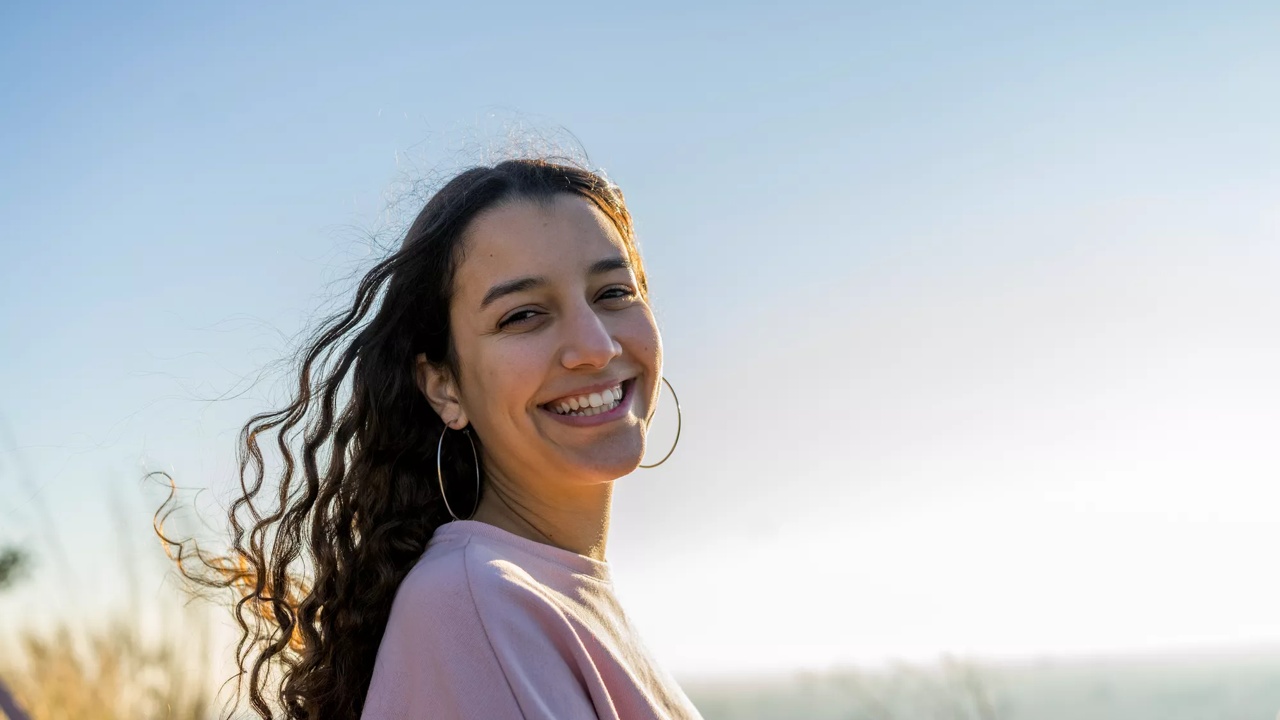 Smiling teenager in light purple t-shirt