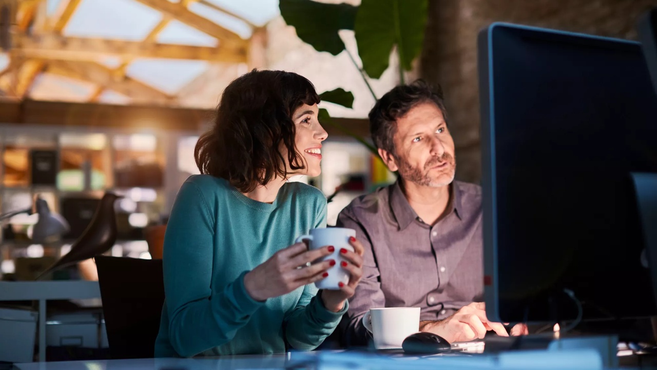 Two adults looking into a screen