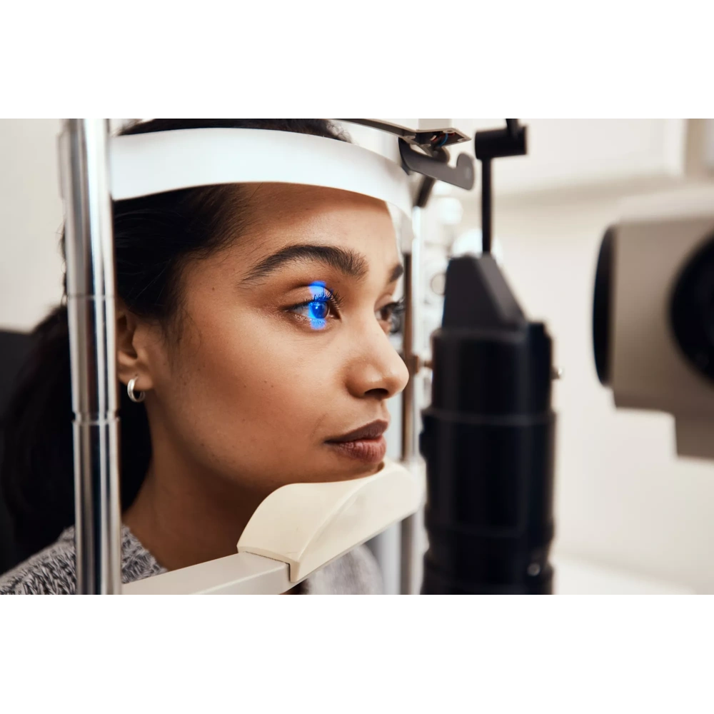 Female Eye Care Professional using equipment to give patient exam