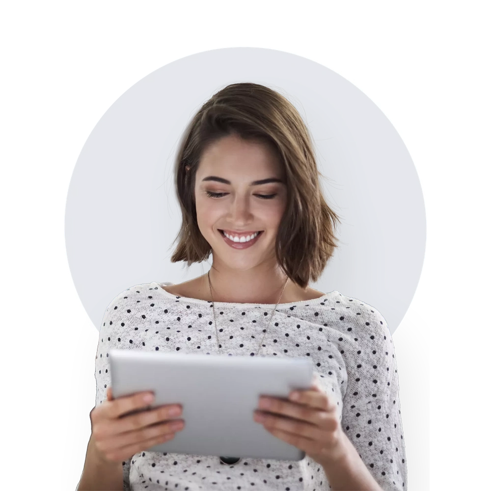 Smiling young woman looking at a tablet