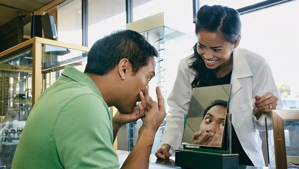 a guy putting on contact lens