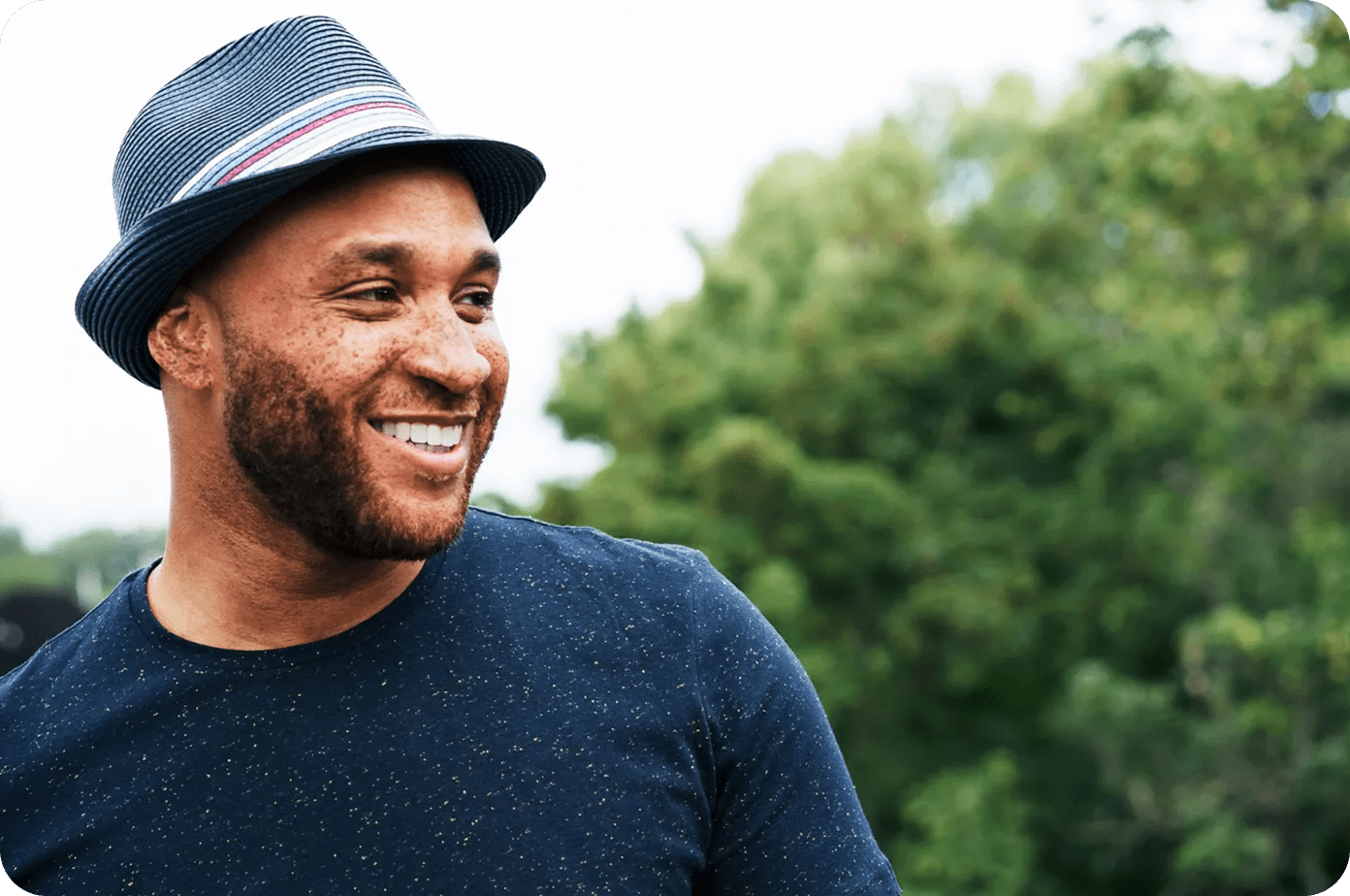 Cheerful bearded Black man smiling outside