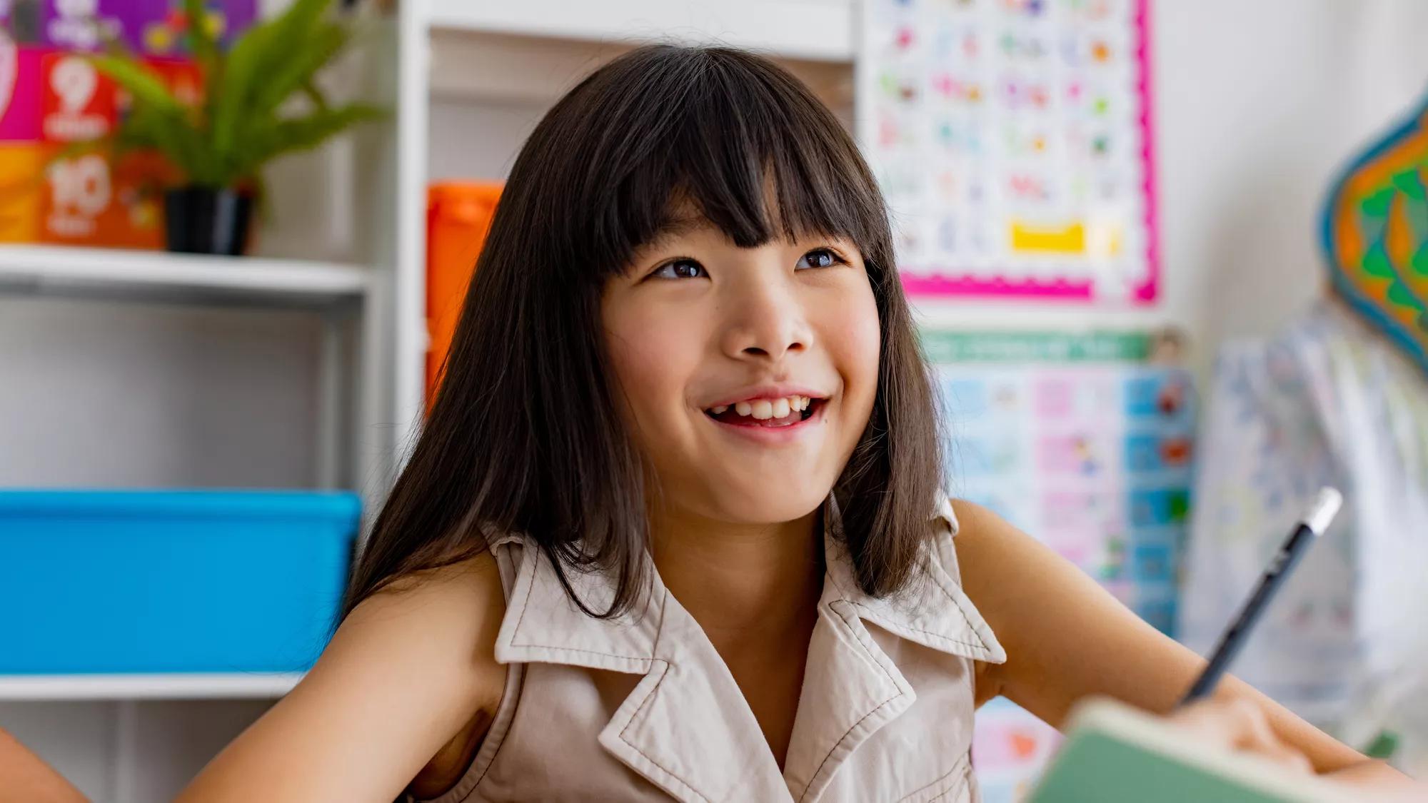 Young asian girl smiling in classroom at school