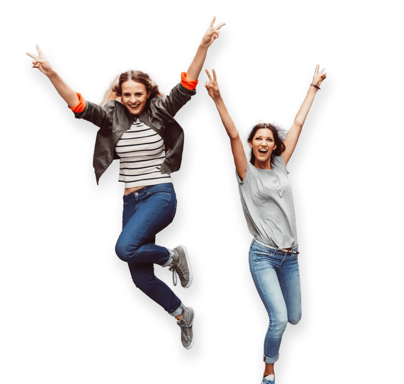 Two happy women in a moment of celebration, jumping with big smiles and arms stretched out 