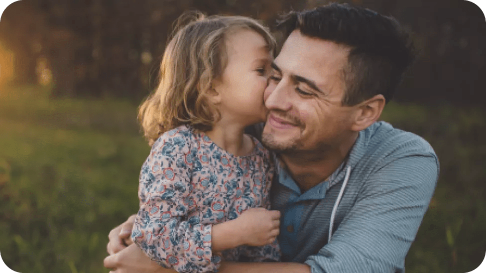 Child kissing parent's cheek